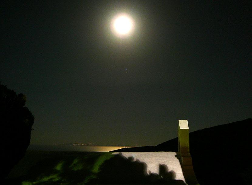 Full moon on a starry night on the island of Sikinos in Greece.