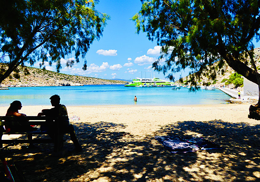 Sunbeds, parasols and shady tamarisk trees at the port beach at Iraklia.