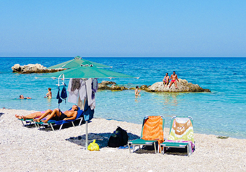 Sunbeds and parasols on Apella beach in Karpathos.