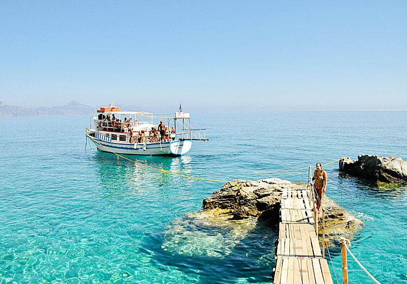 Bech and excursion boats at Kato Lakos beach on Karpathos in Greece.