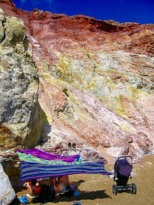 Volcanic colourful mountains and cliffs surround Paleochori beach on Milos.