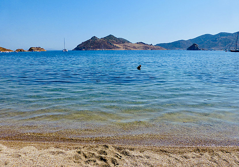 The uninhabited island of Tragonissi and the rock and beach of Petra near Grikos on Patmos in the Dodecanese Islands.