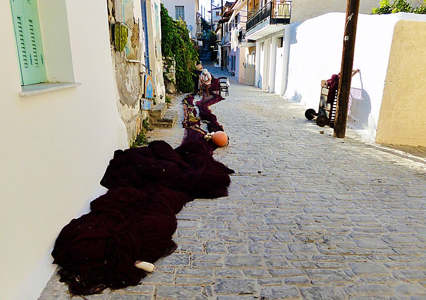 An fishing woman repairs her nets in the least touristy parts of Koroni.