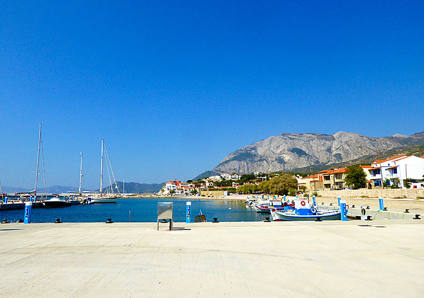 In the port are colourful fishing boats and sailboats that have Ormos as their night port.