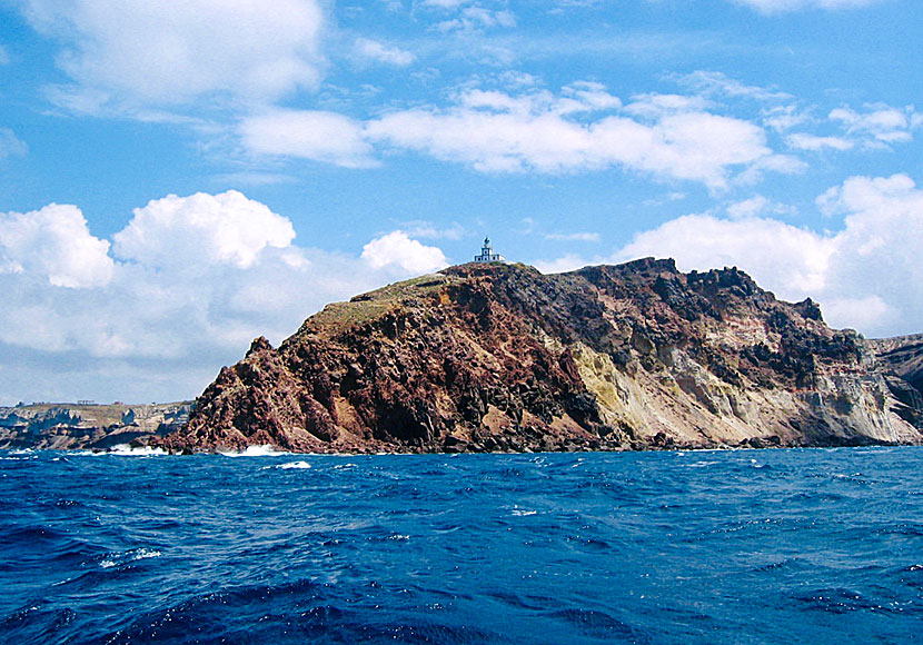 The lighthouse at Cape Akrotiri on Santorini seen from the sea.