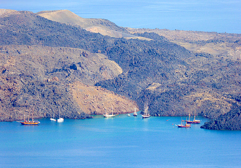 Excursion boats at the volcano Nea Kameni on Santorini in Greece.