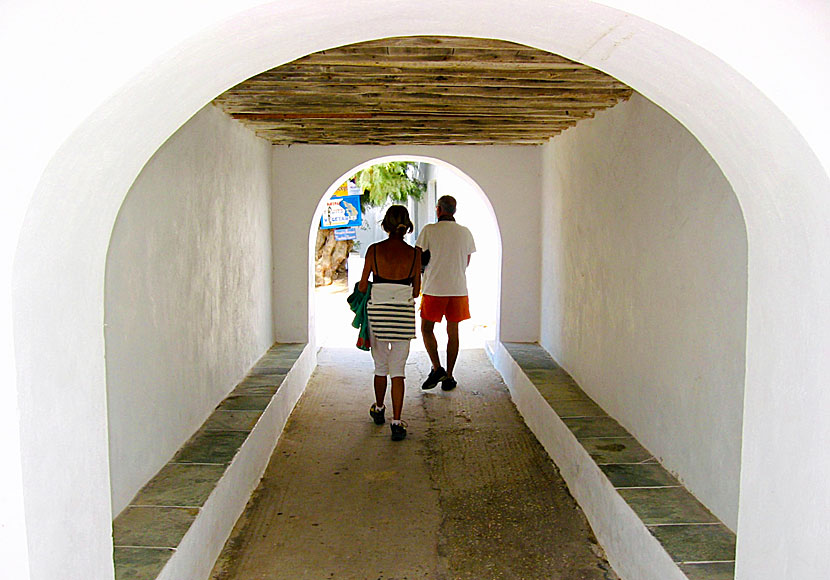 From the Church of Taxiarchis in Vathy, you go through an arch and then come to a sandy beach and several taverns.